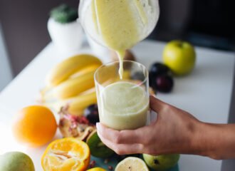 A fruit smoothie being poured into a glass