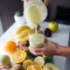 A fruit smoothie being poured into a glass
