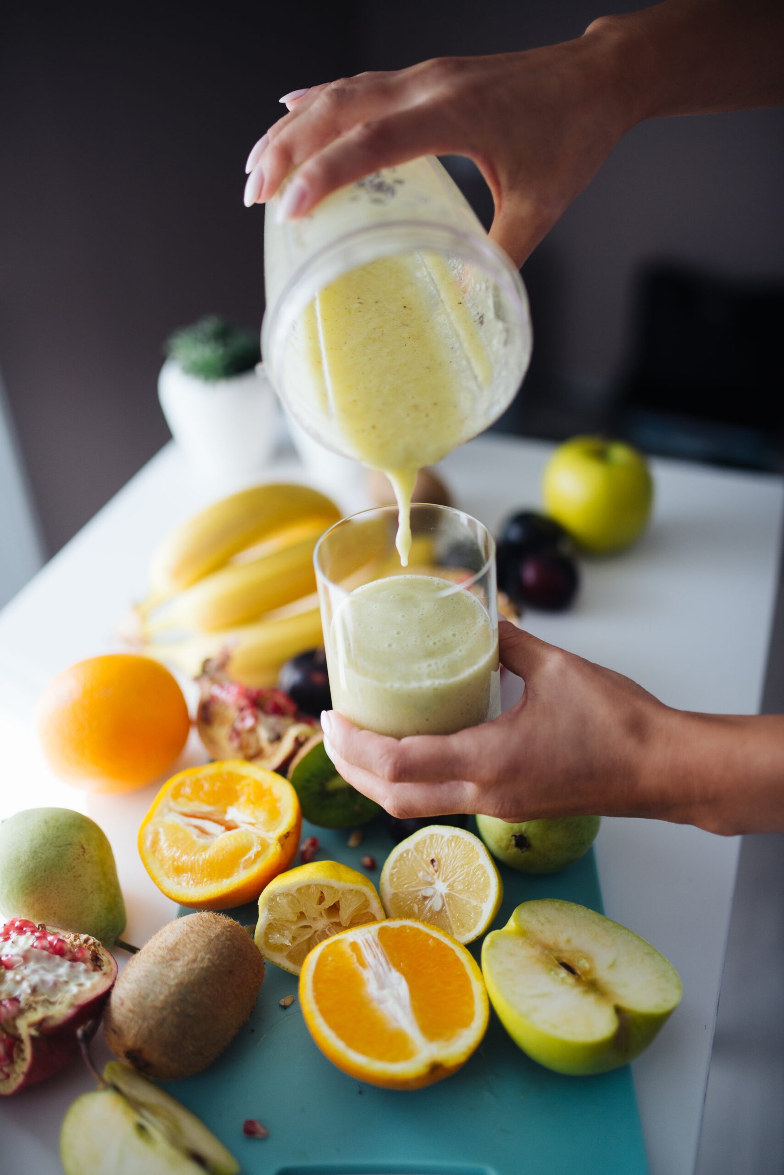 A fruit smoothie being poured into a glass