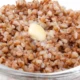 A bowl of cooked buckwheat groats (kasha) topped with a pat of melting butter